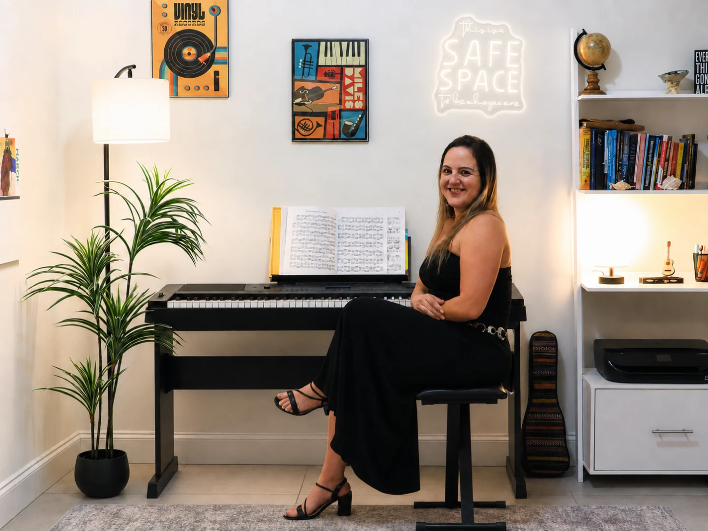 debora seated piano Debora Pedrosa seated at the digital piano in her music studio.